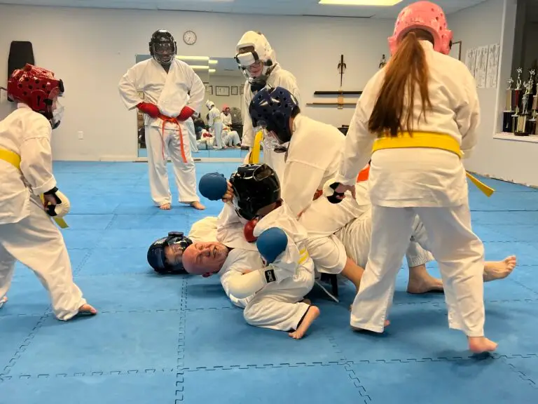 Image of Charlestown, Indiana Shotokan Karate Sensei playfully wrestling with his students on the dojo floor.