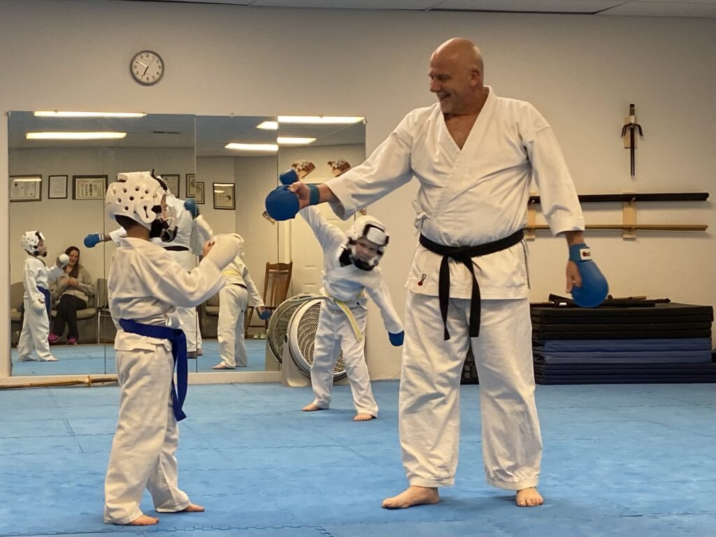 Image of Charlestown, Indiana Shotokan Karate Sensei congratulating a student.