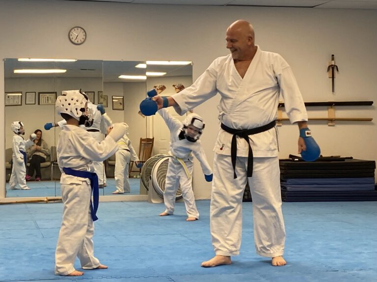 Image of Charlestown, Indiana Shotokan Karate Sensei congratulating a student.