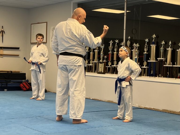 Image of Charlestown, Indiana Shotokan Karate Sensei instructing a blue belt student.