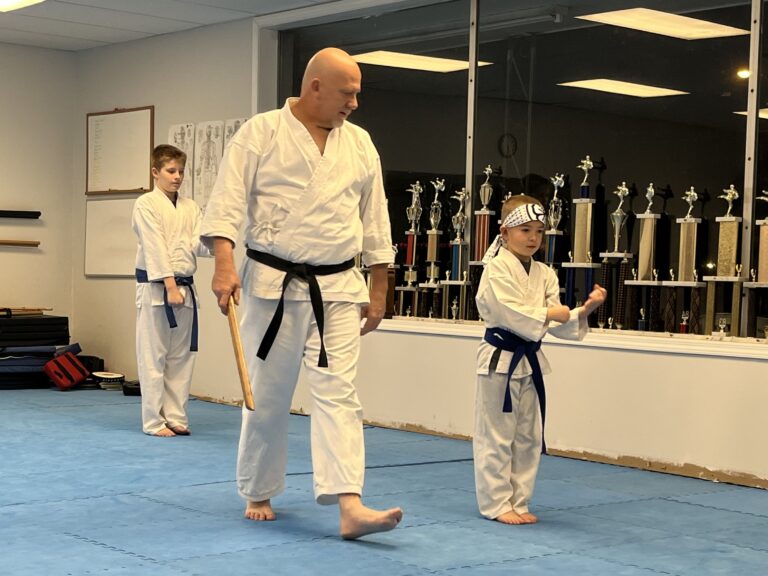 Image of Charlestown, Indiana Shotokan Karate Sensei training kata with his blue belt student.