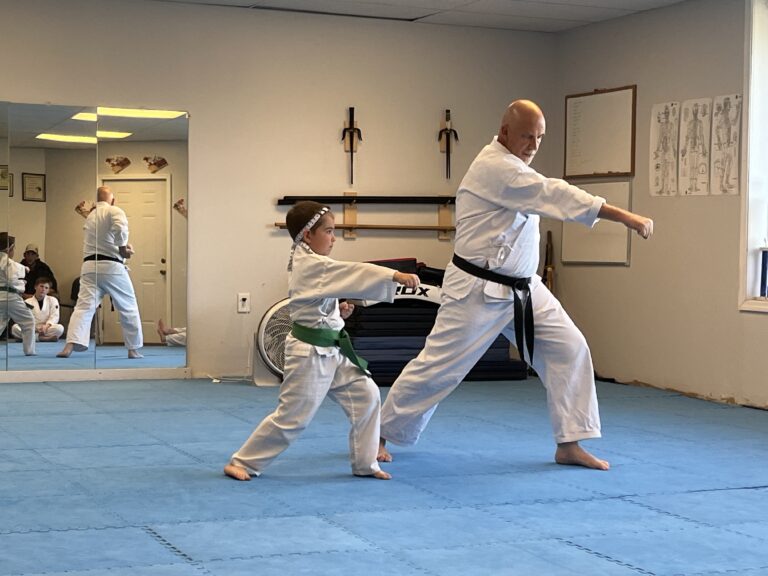 Image of Charlestown, Indiana Shotokan Karate Sensei training kata with his green belt student.