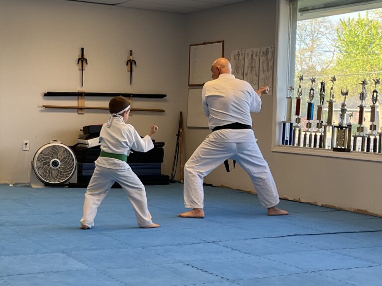 Image of Charlestown, Indiana Shotokan Karate Sensei trianing Kata with his green belt student.