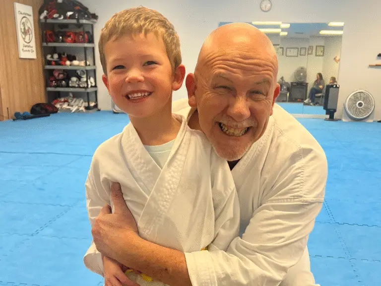 Image of Charlestown, Indiana Shotokan Karate Sensei huggin his favorite student.